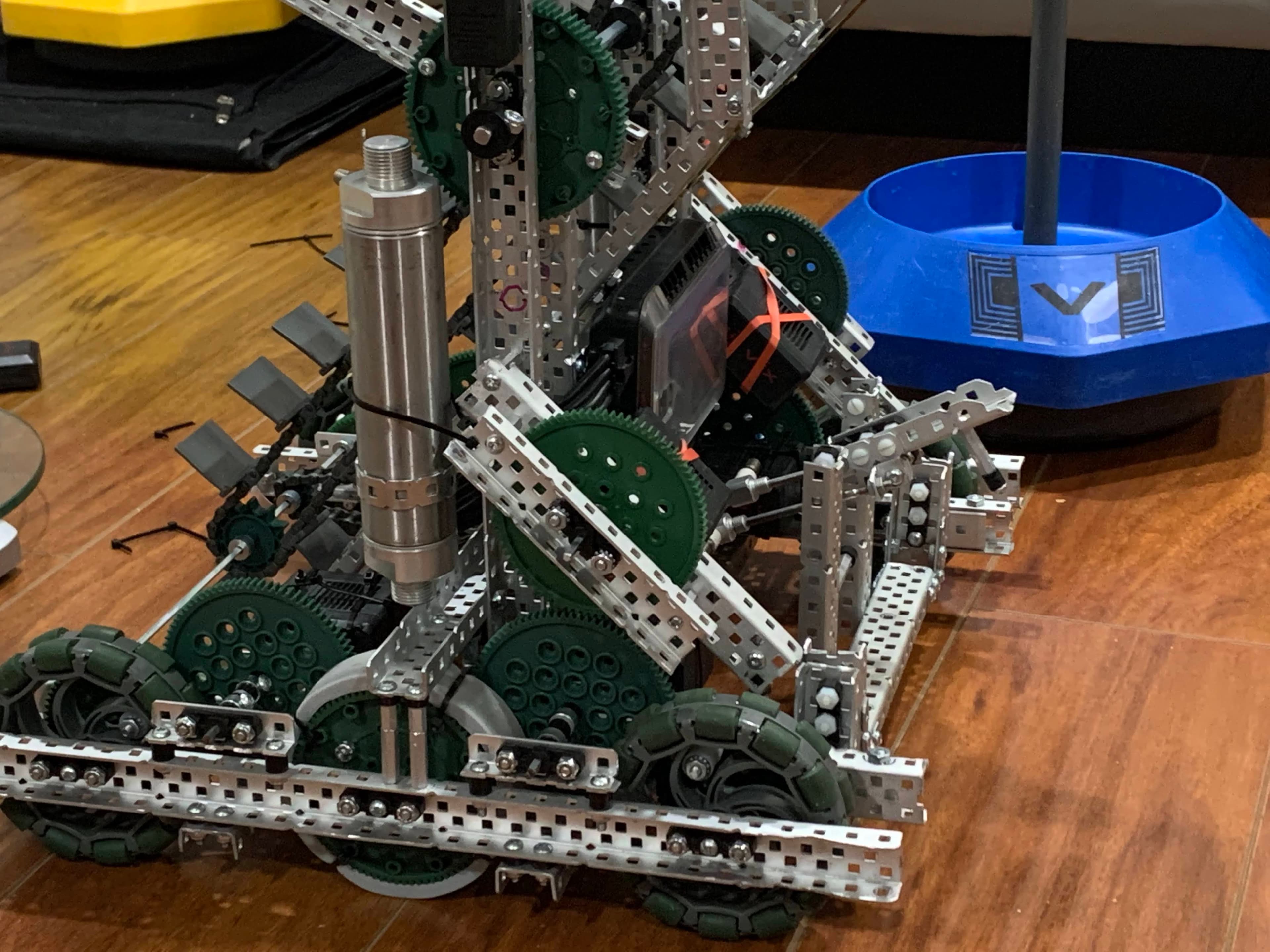 I added systems like pneumatic pistons (at about 100psi) and 8 DC Motors to perform tasks. Also uses inertial sensors and other sensors (added after this picture) like optical sensors, distance sensors, and GPS sensors to navigate the field. The robot operates on a 6 motor drivebase and reaches speeds of 280rpm on 4 inch wheels. Uses center traction wheels to climb up platforms and omnidirectional wheels to increase manueverability.